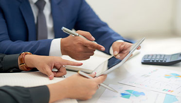 Managed Market Data consultants in Whitestone, NY, reviewing market data management analytics on a tablet.