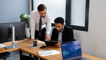 Managed Market Data specialists in Whitestone, NY, reviewing fintech consulting analytics on a tablet.