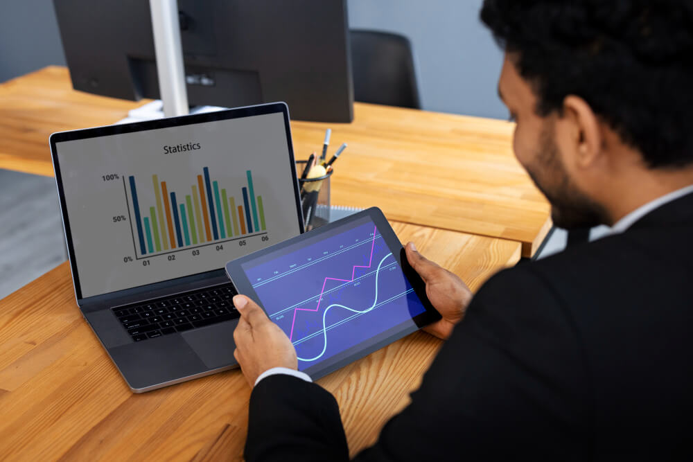 Fintech consulting professional in Whitestone, NY, analyzing market data management performance graphs.